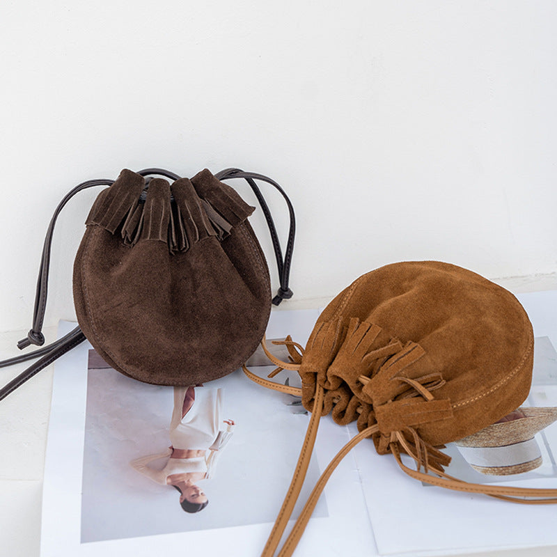 Compact bucket bag silhouette with drawstring top closure