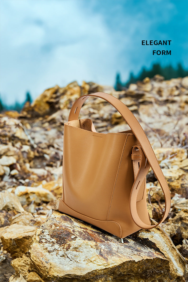 Golden Brown bucket bag on rocky outdoor surface