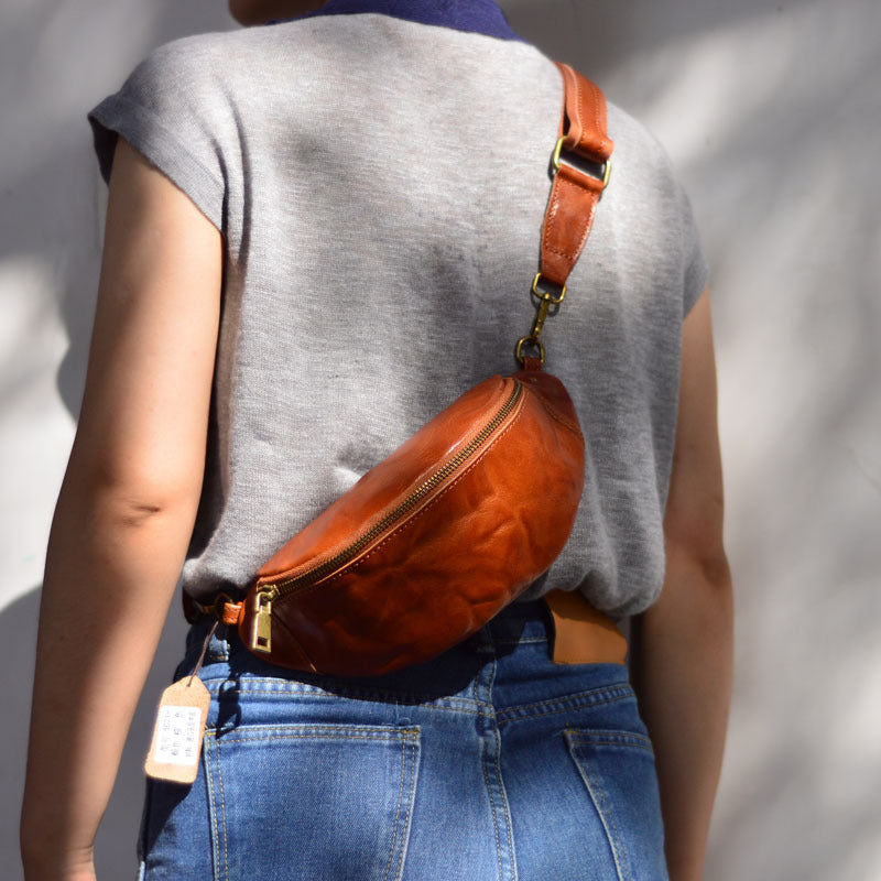 Brown leather waist bag shown from the back while worn crossbody