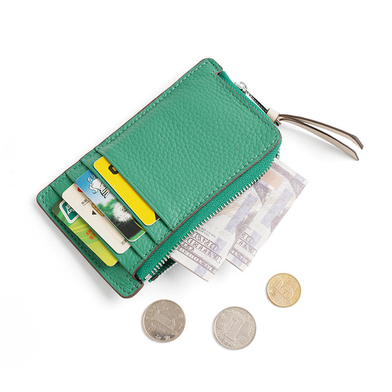 Open green wallet showing 6 card slots, zip compartment with coins and folded bills