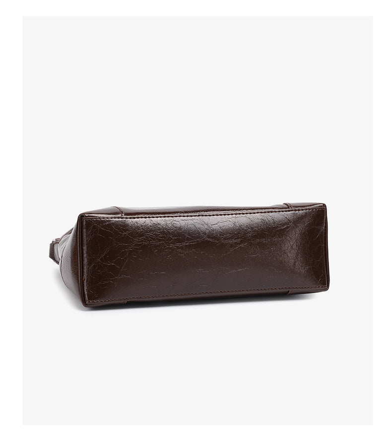 Bottom view of coffee brown leather shoulder bag showing structured base