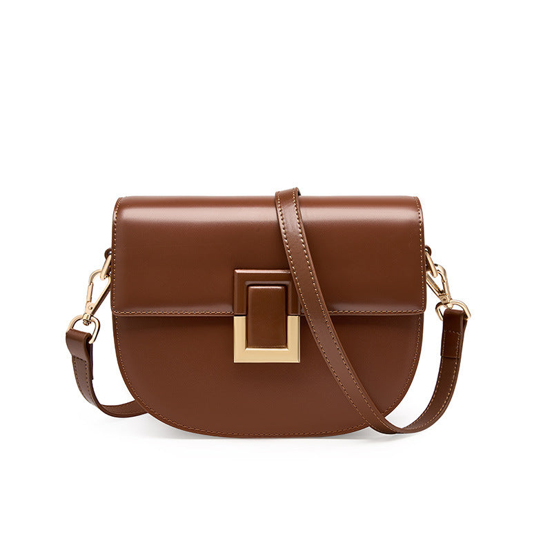 Brown cowhide saddle crossbody bag with gold-tone turn-lock, front view
