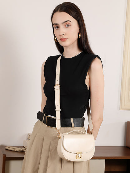 Model wearing cream saddle bag crossbody with adjustable strap
