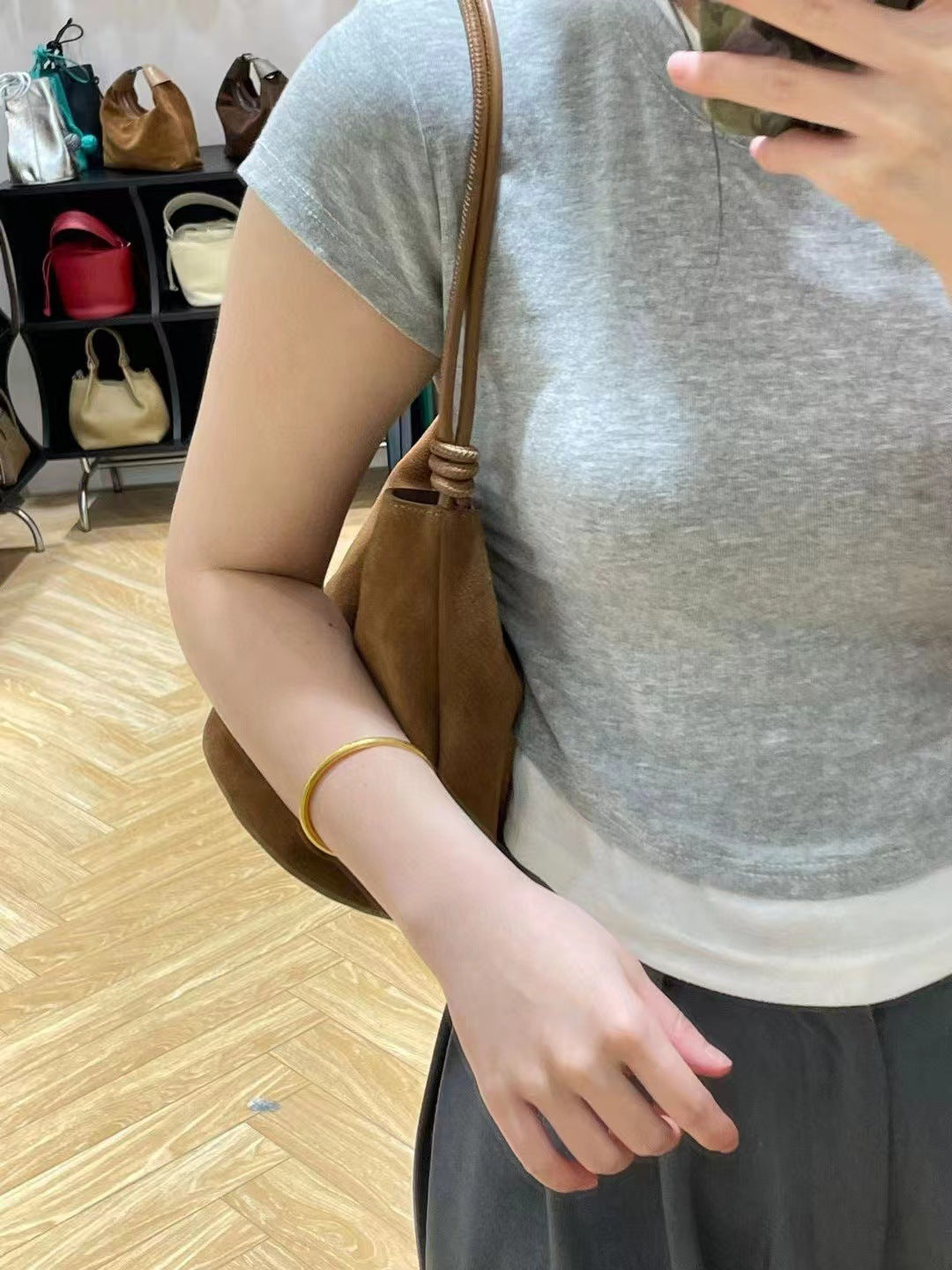 Brown shoulder bag worn close to the body