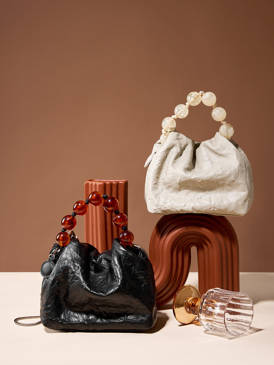 Black and off-white crinkle bags styled on terracotta props