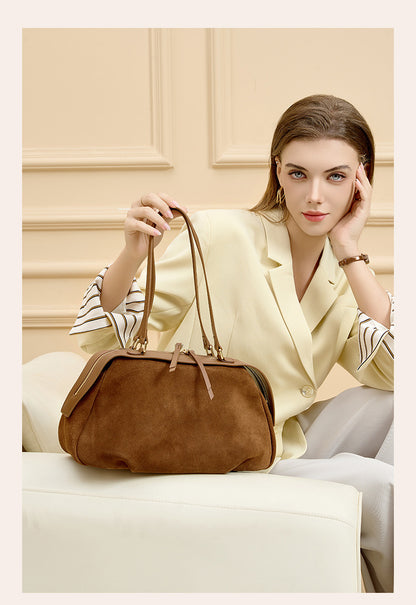 Model carrying the brown shoulder bag at her side