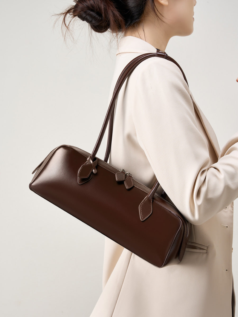 Wine red leather baguette shoulder bag carried under arm