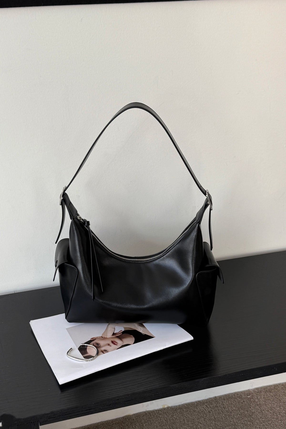 Black cowhide hobo shoulder bag with zip top, front view