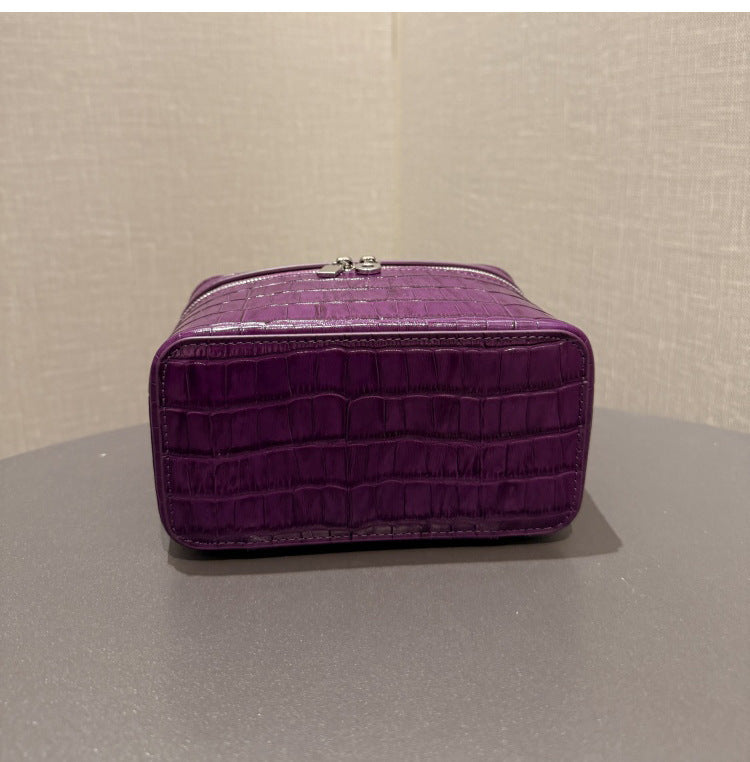 Back view showing the pouch handle and embossed leather panel