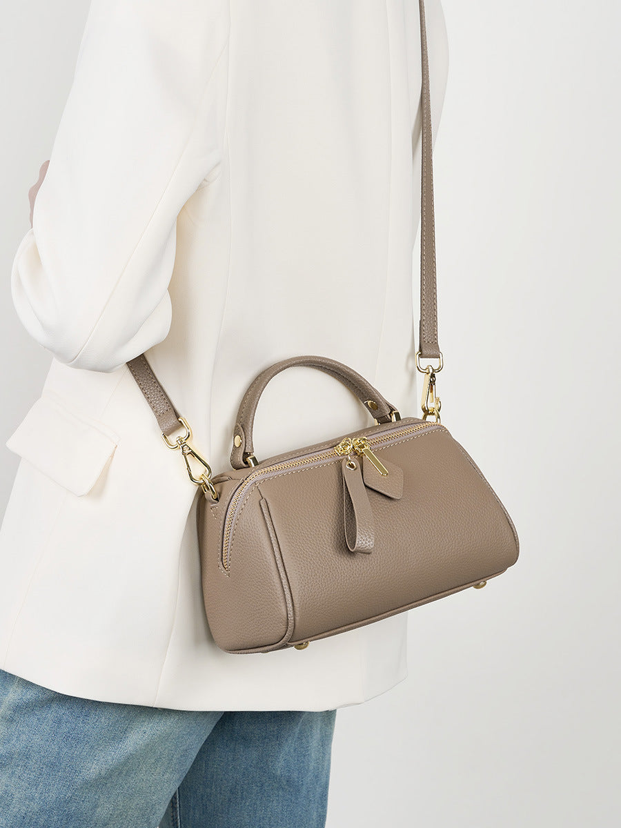 Model wearing gray mini Boston bag crossbody over white blazer and jeans