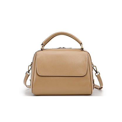 Apricot cowhide leather Boston bag with flap top and dual straps on white background