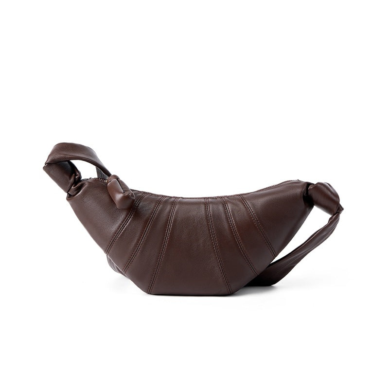 Coffee lambskin crescent bag side profile showing slouchy silhouette