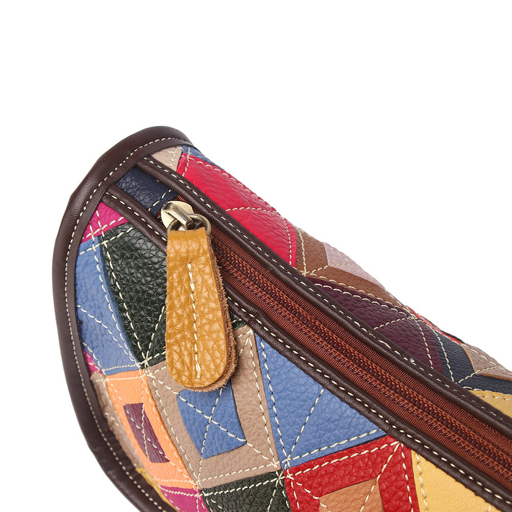 Close-up of the bag's zipper and colorful stitched leather panels