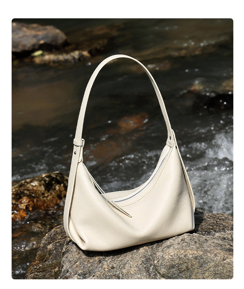 Ivory white hobo bag against flowing water background