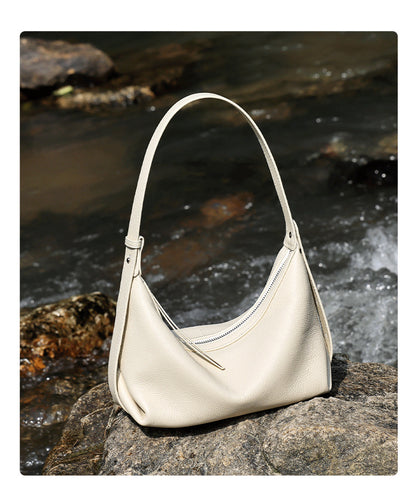 Ivory white hobo bag against flowing water background