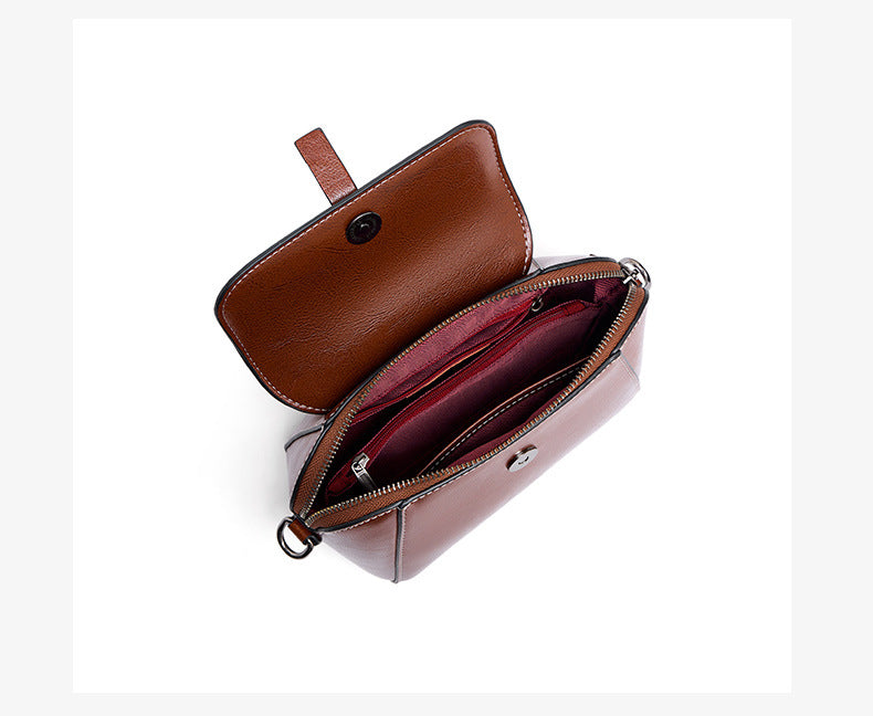 Top-down interior view of brown crossbody bag showing zip pocket and fabric lining