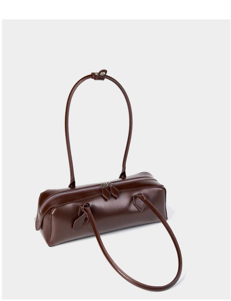 Coffee leather baguette bag angled rear view showing strap loop