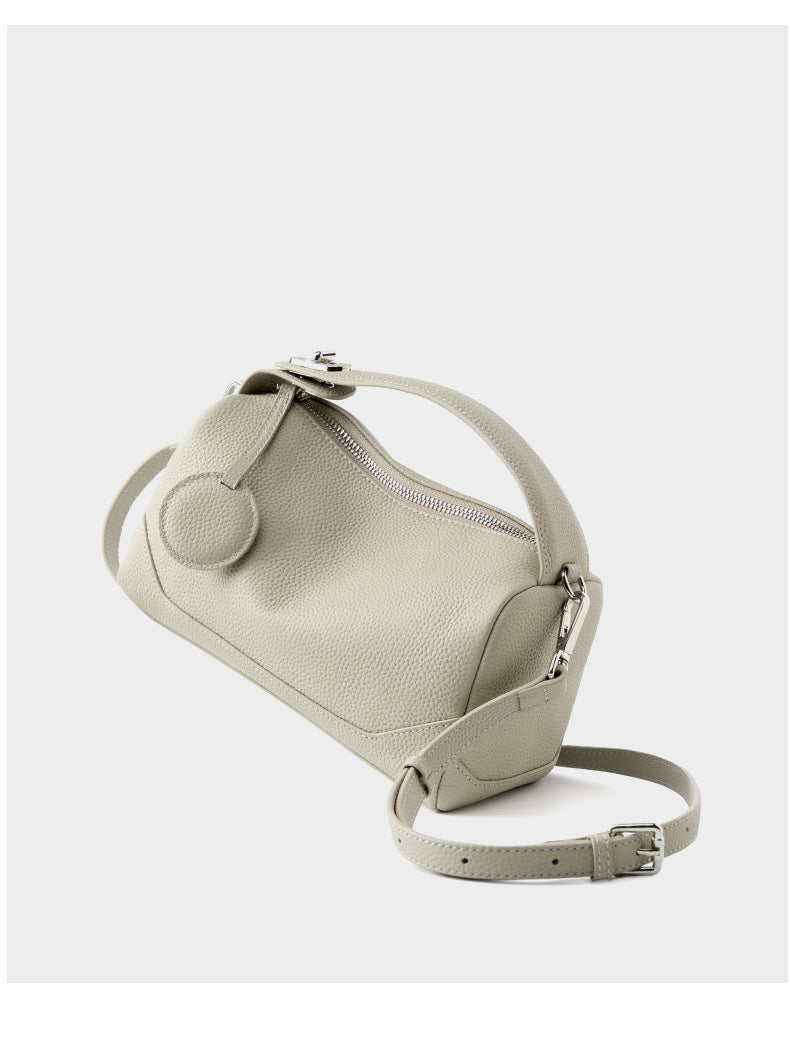Ash white mini Boston bag with adjustable shoulder strap laid flat