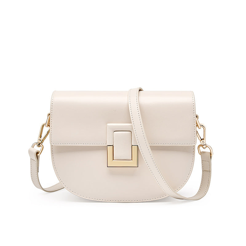 White cowhide saddle crossbody bag with gold-tone turn-lock, front view