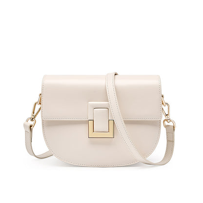 White cowhide saddle crossbody bag with gold-tone turn-lock, front view