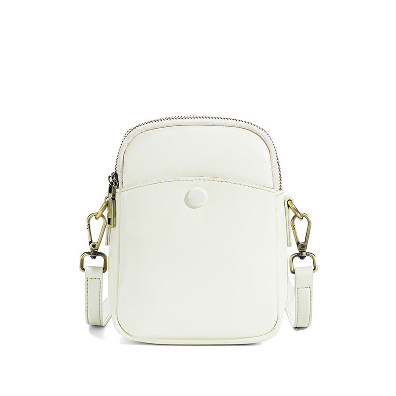 White cowhide leather mini crossbody bag showing front slip pocket detail