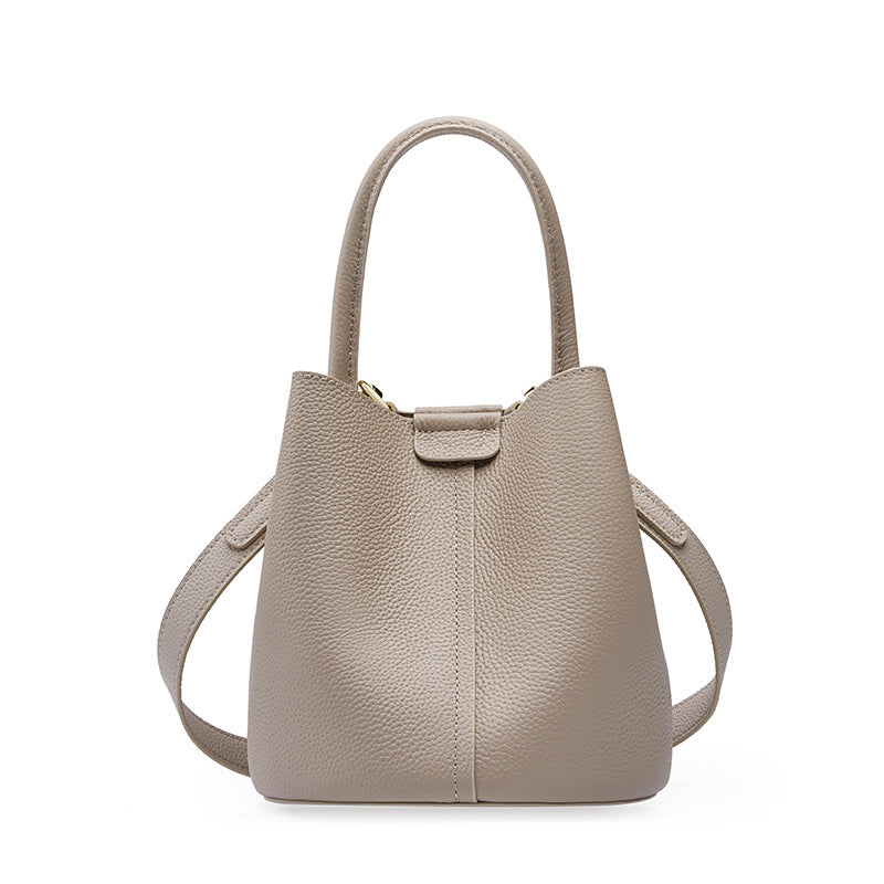 Milk tea beige pebbled cowhide mini bucket bag with top handle