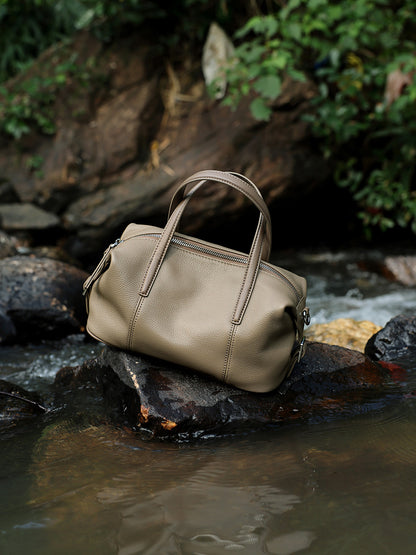 Elephant gray bag resting on a rock by a stream