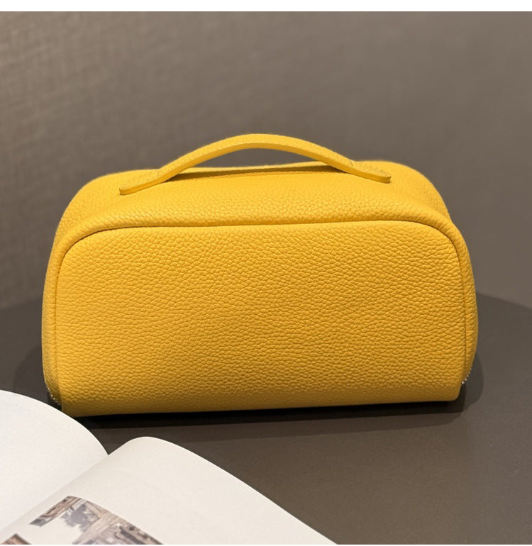 Yellow cowhide pouch shown from an angled side view