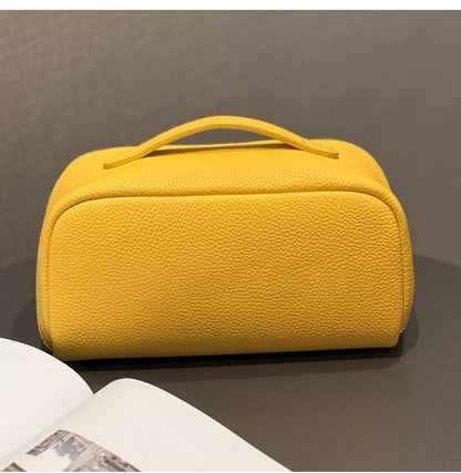 Yellow cowhide pouch shown from an angled side view