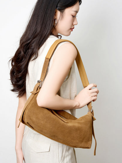 Model wearing the suede bag as a shoulder purse