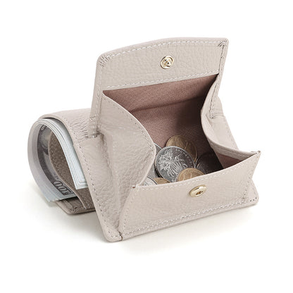 Open ivory leather coin purse with internal divider holding coins and folded cash