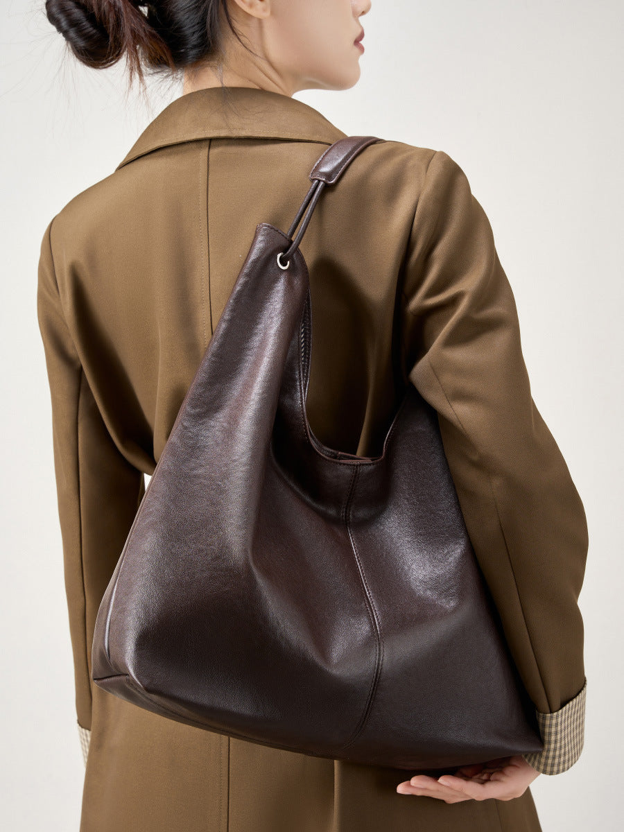 Brown hobo tote bag worn on the shoulder viewed from behind