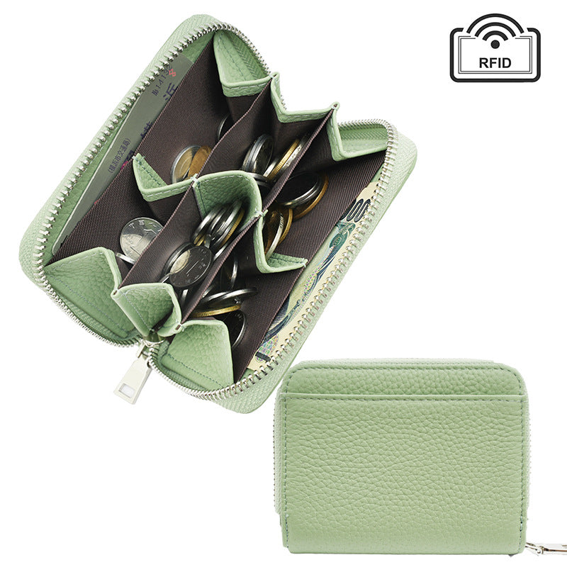 Light green compact leather wallet displayed at an angle
