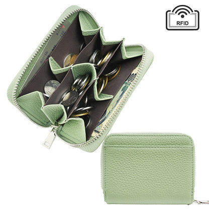Light green compact leather wallet displayed at an angle