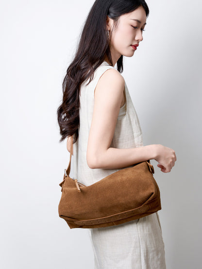 Side view showing the soft shape and shoulder strap