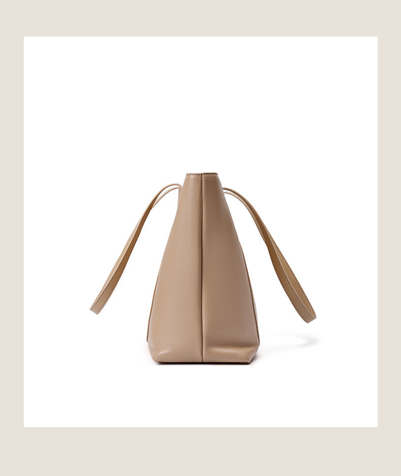 Side profile of apricot leather tote bag showing depth and stitching