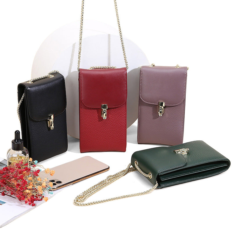 Four cowhide phone crossbody bags in black, wine red, taro purple, and dark green displayed with phone and accessories