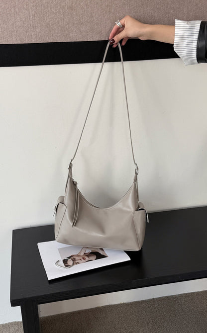 Brown hobo bag showing its shoulder strap and soft shape