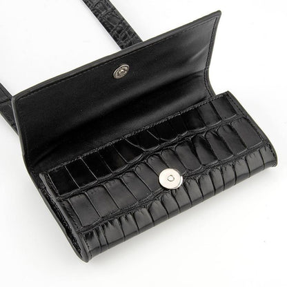Open black belt bag showing magnetic closure and interior slip pocket
