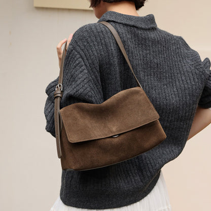 Caramel leather flap shoulder bag worn over the shoulder