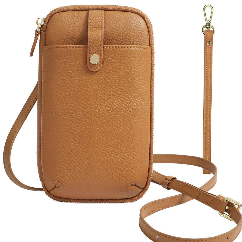 Caramel brown leather phone bag with pebbled texture and adjustable shoulder strap
