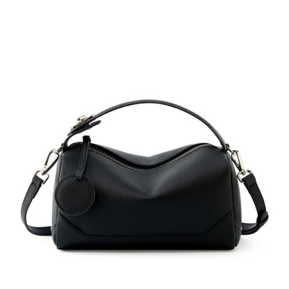 Midnight black top-grain cowhide mini Boston bag with top handle on white background