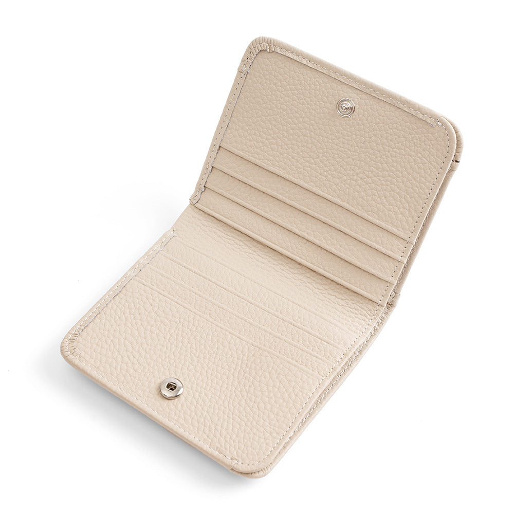 Open ivory wallet showing 8 card slots and inner structure