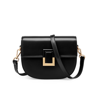 Black cowhide mini saddle crossbody bag with gold-tone turn-lock, front view