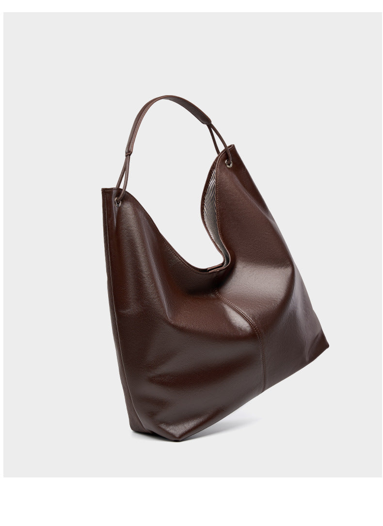 Dark brown hobo tote bag angled side view on light gray background