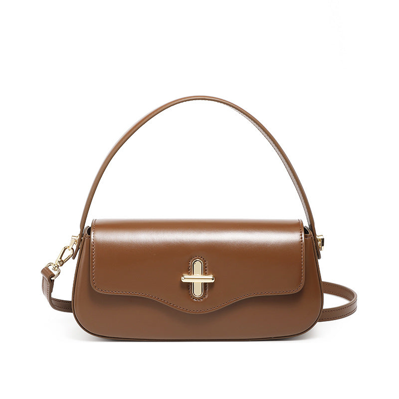 Caramel cowhide leather baguette bag front view on plain background