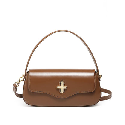 Caramel cowhide leather baguette bag front view on plain background