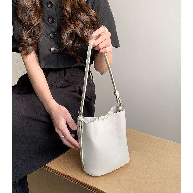 Brown bucket bag shown against a plain white background