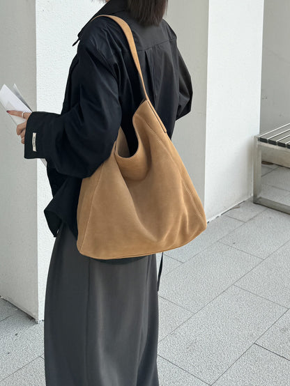 Dark brown tote showing the deep body and strap