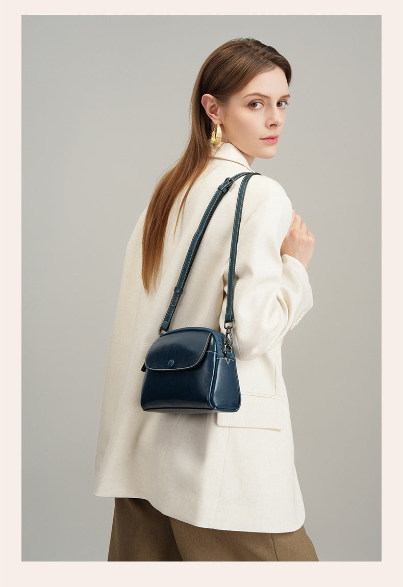 Model carrying peacock blue crossbody bag crossbody style